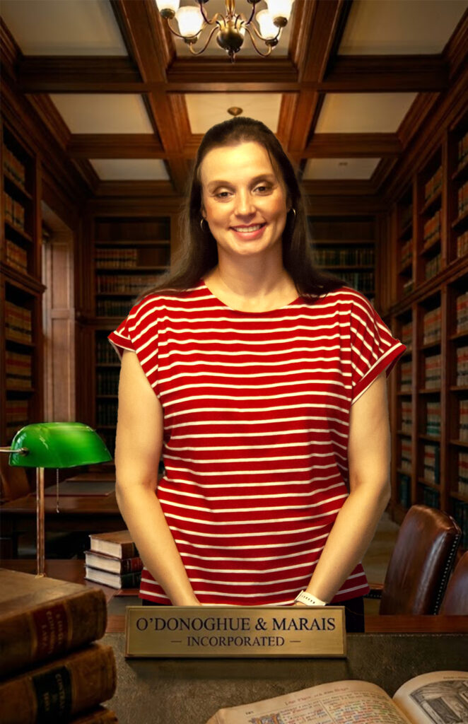 Professional corporate lawyer sitting in the legal library at O'Donoghue & Marais Incorporated, a leading law firm in Springs.
