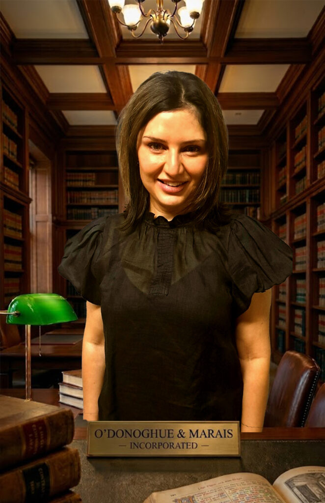 Professional corporate lawyer sitting in the legal library at O'Donoghue & Marais Incorporated, a leading law firm in Springs