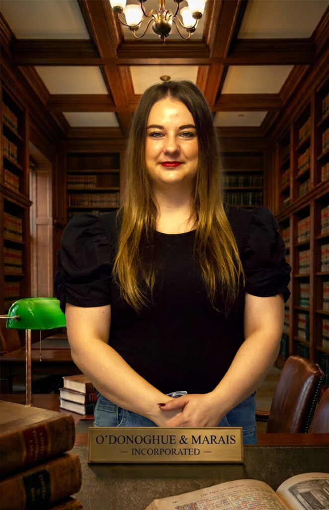 Professional corporate lawyer sitting in the legal library at O'Donoghue & Marais Incorporated, a leading law firm in Springs